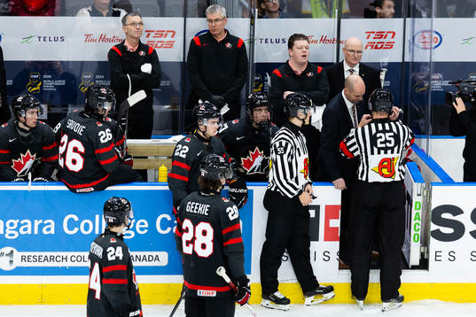 Referee Tobias Björk and head coach Alan Letang of Canada