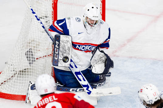 Goaltender Markus Stensrud saves a shot from Jonas Taibel