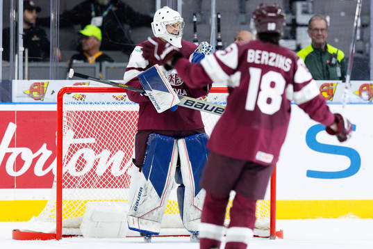 Goaltender Deivs Rolovs of Latvia celebrates