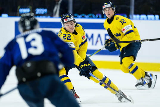 Anton Wahlberg of Sweden gets the puck in his face