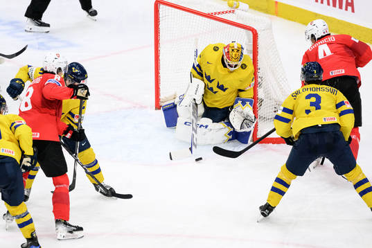 Goaltender Hugo Hävelid of Sweden and Rodwin Dionicio of