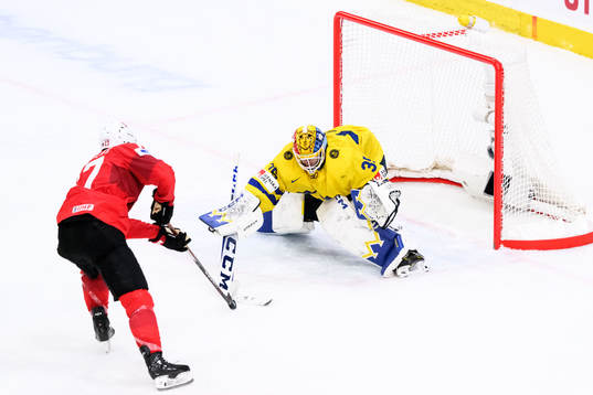 Miles Muller of Switzerland and goaltender Hugo Hävelid of