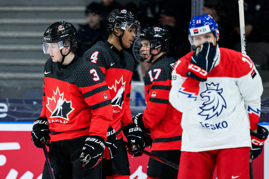 Jake Furlong, Noah Warren and Macklin Celebrini of Canada