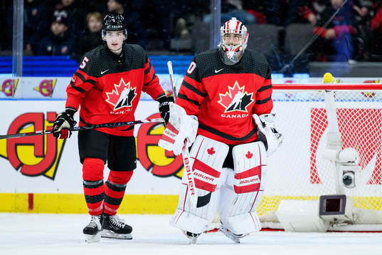 Oliver Bonk and goalkeeper Mathis Rousseau of Canada