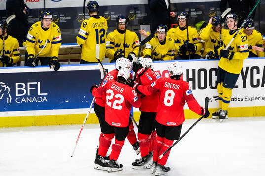 Nick Meile of Switzerland celebrates with team mates
