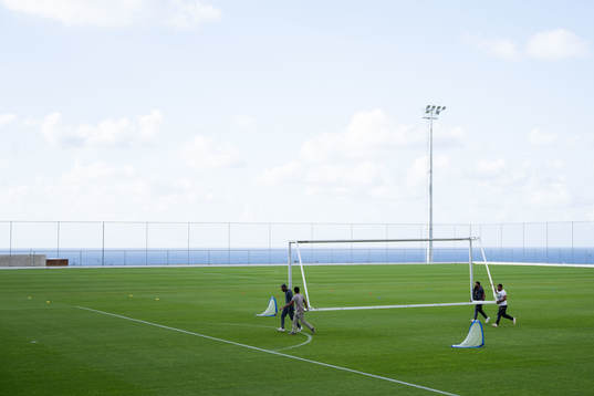 Builders carrying a goal frame