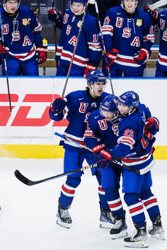 Cutter Gauthier and Seamus Casey celebrate with Isaac Howard