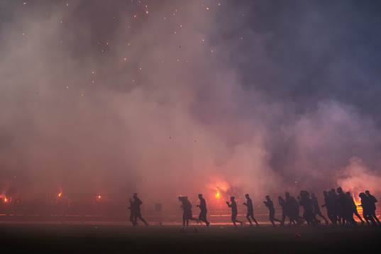 Spelarna framför rök av fyrverkerier och pyroteknik