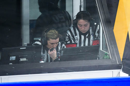 Referees conducting a video review