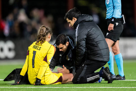 Goalkeeper Lena Pauels of Benfica receives medical attention