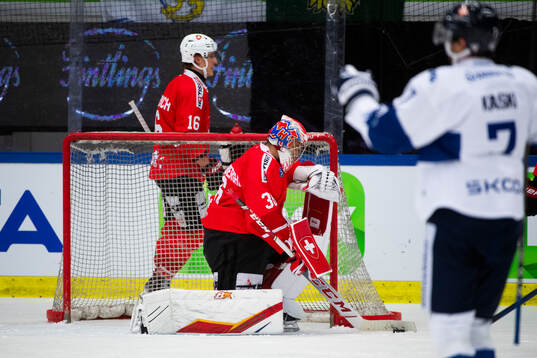 Oliwer Kaski of Finland scores and goaltender Joren Van