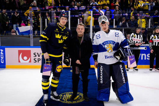 Gabriel Carlsson of Sweden and goaltender Emil Larmi of