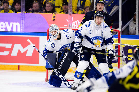 goaltender Emil Larmi of Finland and Jacob De La Rose of