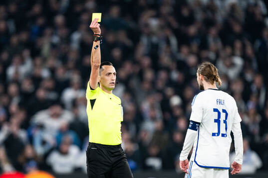 Rasmus Falk of FC Copenhagen receives a yellow card from
