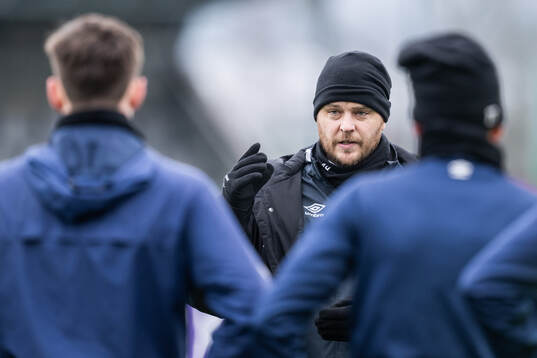 Tränare Andreas Holmberg pratar med spelarna