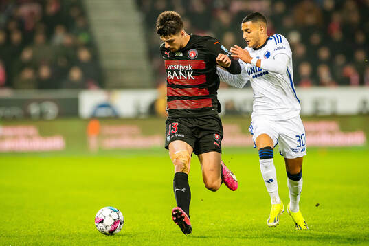 Adam Gabriel of Midtjylland and Elias Achouri of FC