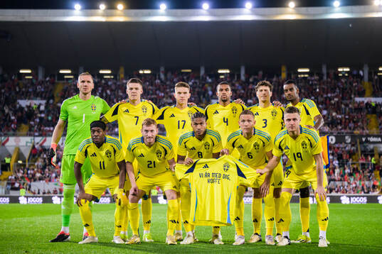 The starting eleven of Sweden pose for a photo as they hold