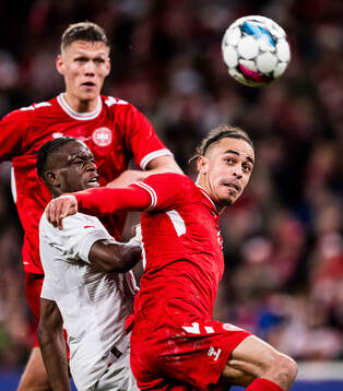 Yussuf Poulsen of Denmark and Danis Zakaria of Switzerland