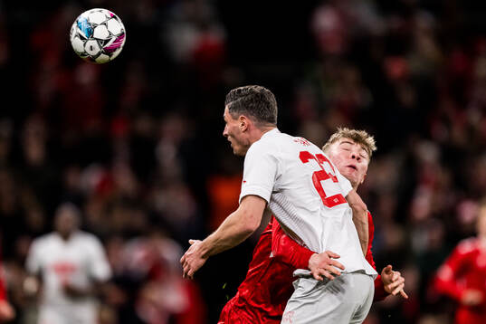 Fabian Schär of Switzerland and Rasmus Højlund of Denmark