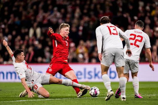 Granit Xhaka of Switzerland and Rasmus Højlund of Denmark