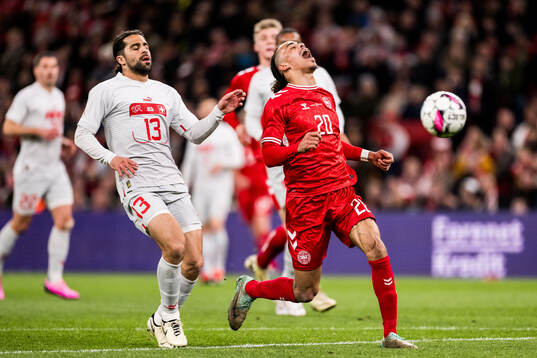 Ricardo Rodriguez of Switzerland and Yussuf Poulsen of