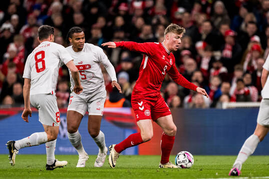 Rasmus Højlund of Denmark and Manuel Akanji of Switzerland