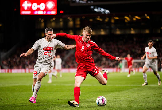 Fabian Schär of Switzerland and Rasmus Højlund of Denmark