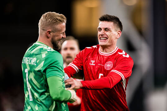 Goalkeeper Kasper Schmeichel and Joakim Mæhle of Denmark
