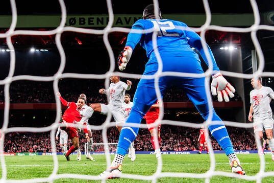 Yussuf Poulsen of Denmark in action against Manuel Akanji