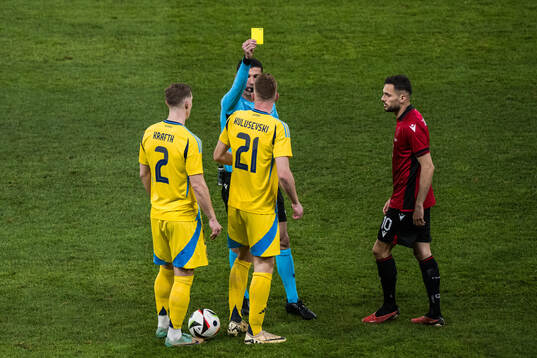 Dejan Kulusevski of Sweden receives a yellow card