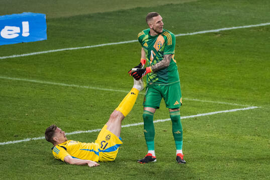 Carl Starfelt and goalkeeper Robin Olsen of Sweden