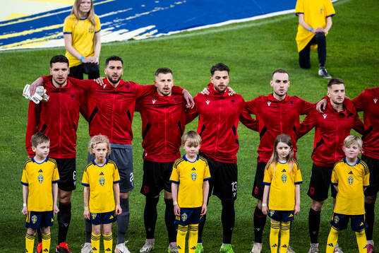 Players of Albania with mascots