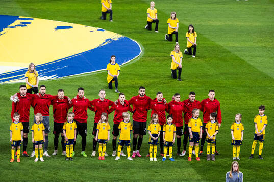 Players of Albania with mascots