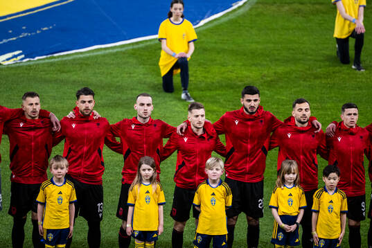 Players of Albania with mascots