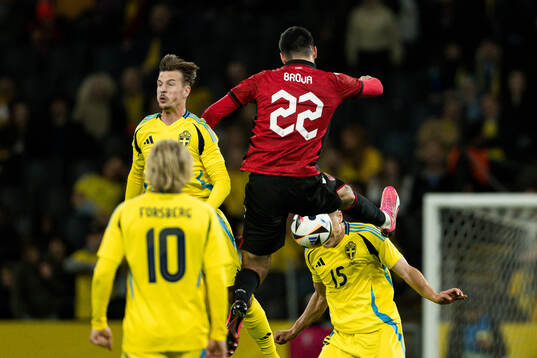 Simon Olsson and Carl Starfelt of Sweden and Armando Broja