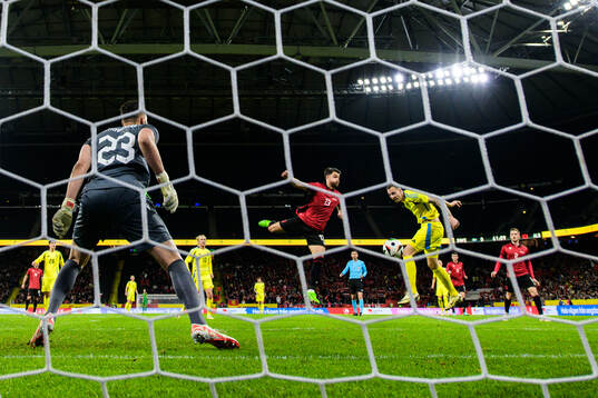 Gustaf Nilsson of Sweden scores 1-0 behind goalkeeper