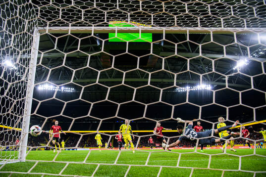 Gustaf Nilsson and Emil Forsberg of Sweden see the ball hit