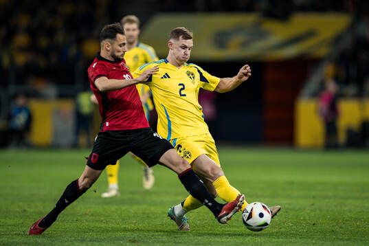 Nedim Bajrami of Albania and Emil Krafth of Sweden