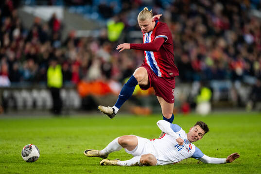 Erling Braut Haaland of Norway and Michal Tomic of Slovakia