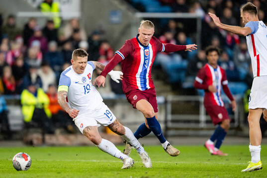Juraj Kucka of Slovakia and Erling Braut Haaland of Norway