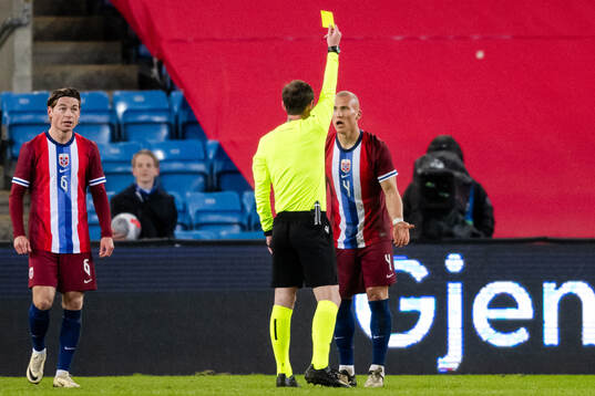 Leo Østigård of Norway receives a yellow card
