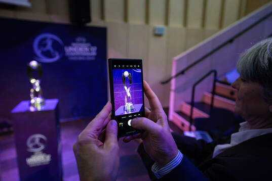 People take pictures of the Trophy