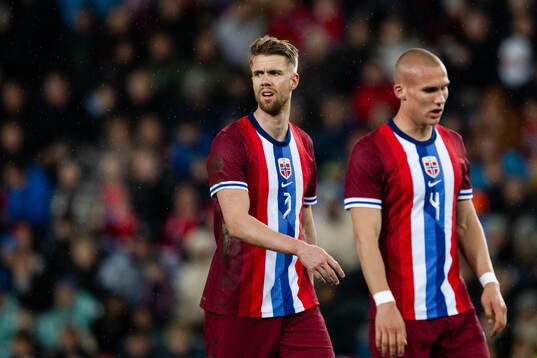 Kristoffer Ajer and Leo Østigård of Norway look dejected