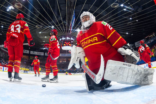 Goaltender Jiahui Zhan of China looks dejected