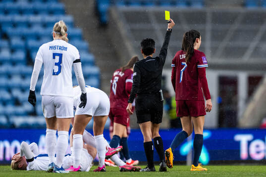 Ingrid Syrstad Engen of Norway receives a yellow card