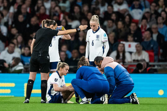 Keira Walsh of England receives medical attention