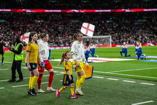 Goalkeeper Jennifer Falk and Kosovare Asllani of Sweden