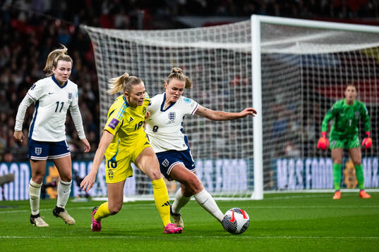 Lauren Hemp and Georgia Stanway of England compete for the