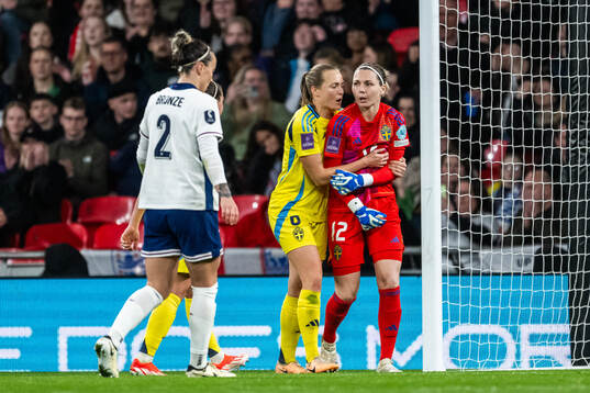 Magdalena Eriksson celebrate with goalkeeper Jennifer Falk