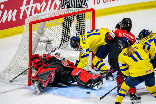 Goaltender Riko Kawaguchi of Japan and Emma Forsgren of